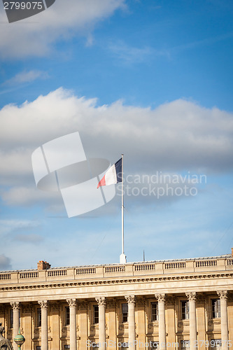 Image of Flag of France fluttering under a serene blue sky