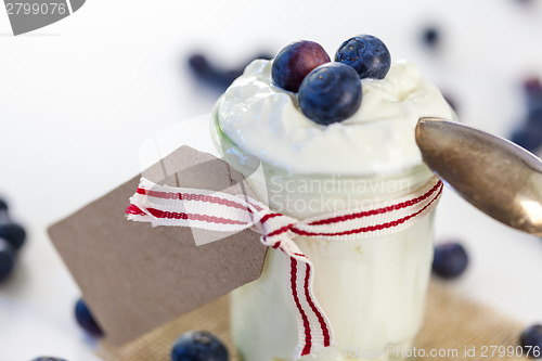 Image of Jar of clotted cream or yogurt with blueberries