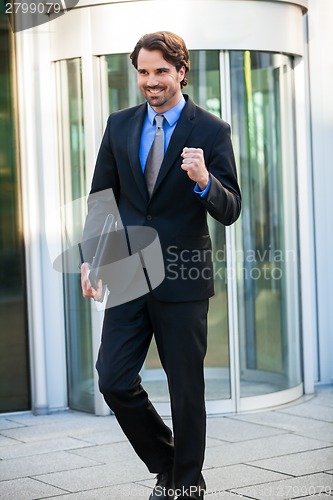 Image of Motivated businessman punching the air