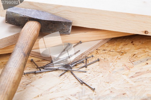 Image of Mallet with nails and planks of new wood