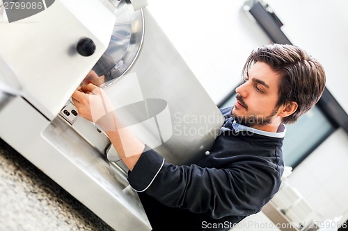 Image of Commercial cook or chef slicing cold meat