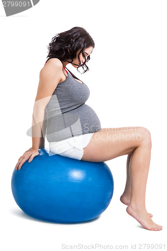 Image of Pregnant woman doing pilates exercises