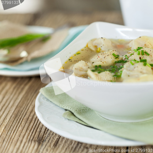 Image of Dish of savory pork tortellini in broth pelmeni russian