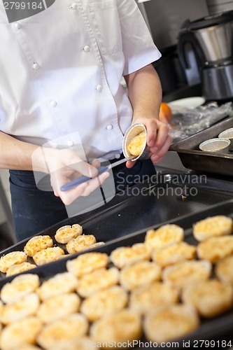 Image of Chef preparing desserts removing them from moulds