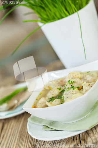 Image of Dish of savory pork tortellini in broth pelmeni russian