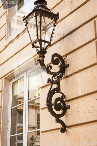 Image of Old wrought iron lamp on a building exterior