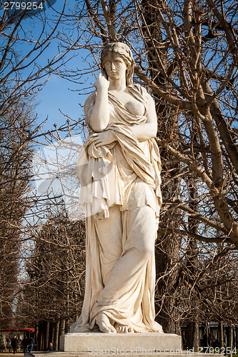 Image of Bird perched on an ancient stone statue