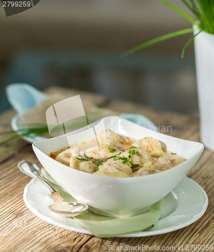 Image of Dish of savory pork tortellini in broth pelmeni russian