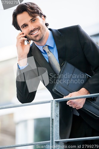 Image of Businessman listening to a call on his mobile