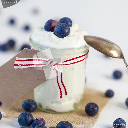Image of Jar of clotted cream or yogurt with blueberries