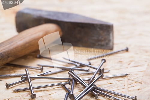 Image of Mallet with nails and planks of new wood