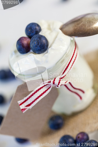 Image of Jar of clotted cream or yogurt with blueberries