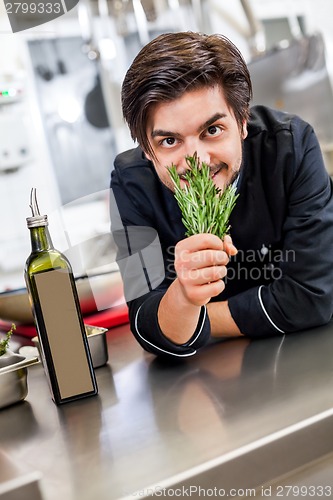 Image of Chef checking the freshness of a bunch of herbs