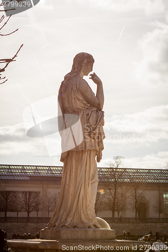 Image of Bird perched on an ancient stone statue