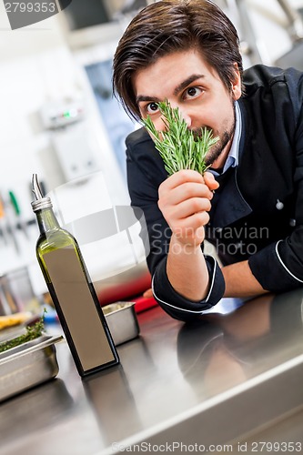 Image of Chef checking the freshness of a bunch of herbs