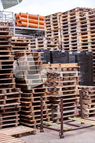 Image of Stacks of old wooden pallets in a yard