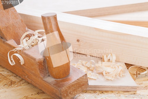 Image of Handheld wood plane with wood shavings