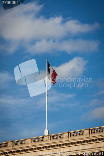 Image of Flag of France fluttering under a serene blue sky