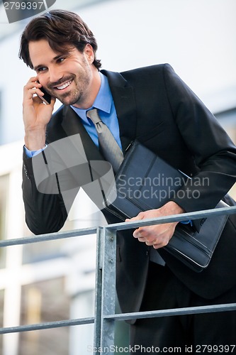 Image of Businessman listening to a call on his mobile