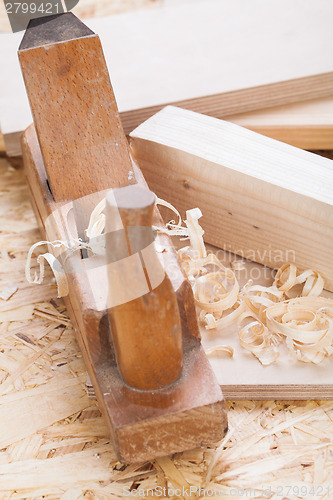 Image of Handheld wood plane with wood shavings