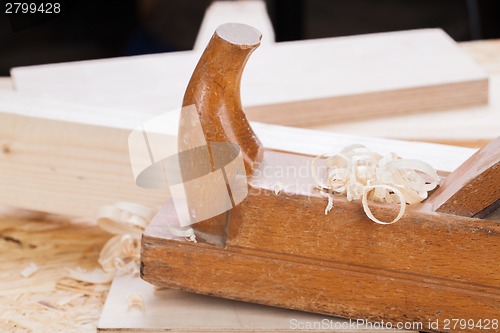 Image of Handheld wood plane with wood shavings