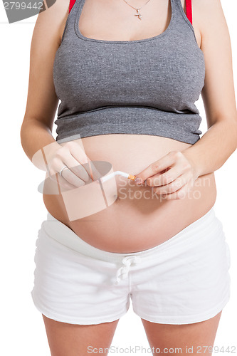 Image of Pregnant woman breaking a cigarette in two