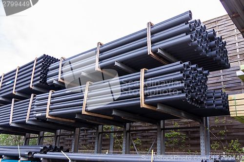 Image of Rolls of plastic pipes in a warehouse yard
