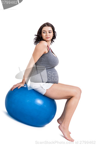 Image of Pregnant woman doing pilates exercises