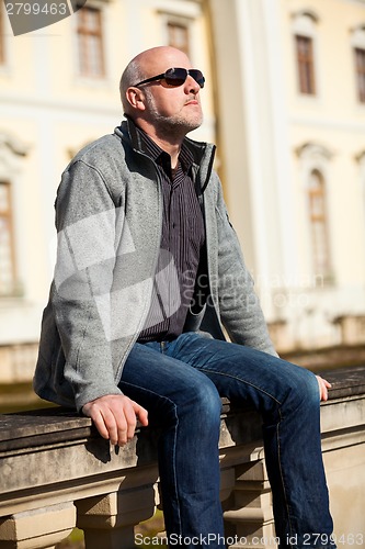 Image of Stylish man in sunglasses enjoying the sun