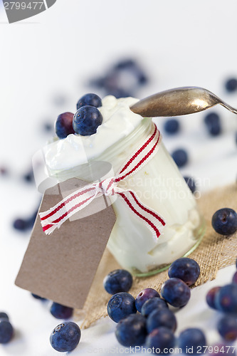 Image of Jar of clotted cream or yogurt with blueberries