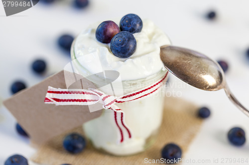 Image of Jar of clotted cream or yogurt with blueberries