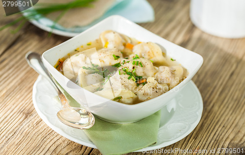 Image of Dish of savory pork tortellini in broth pelmeni russian