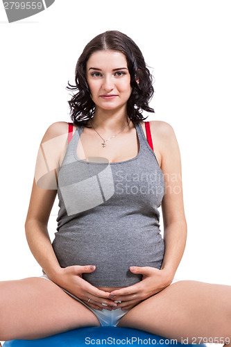 Image of Pregnant woman doing pilates exercises