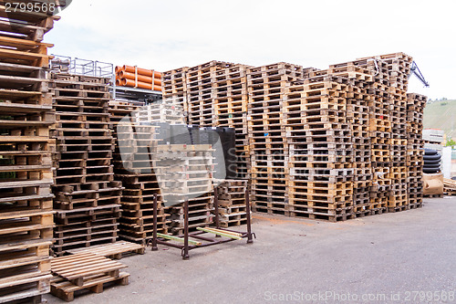 Image of Stacks of old wooden pallets in a yard