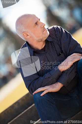 Image of Thoughtful man sitting on a flight of steps