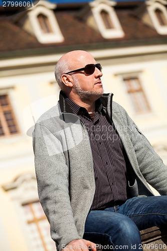 Image of Stylish man in sunglasses enjoying the sun