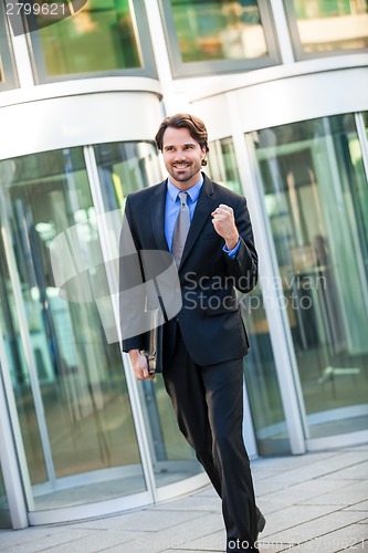 Image of Motivated businessman punching the air