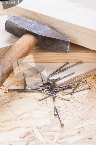 Image of Mallet with nails and planks of new wood