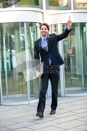 Image of Motivated businessman punching the air