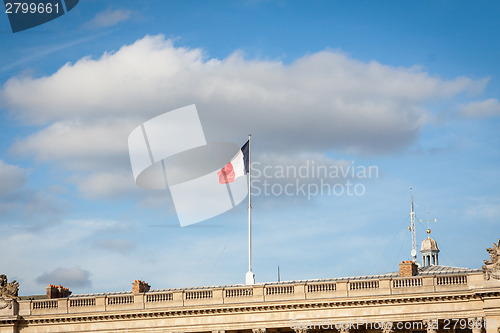 Image of Flag of France fluttering under a serene blue sky