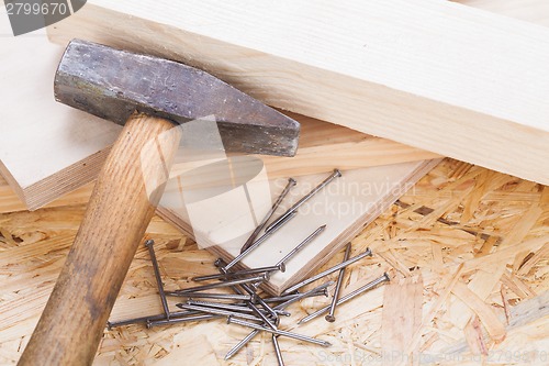 Image of Mallet with nails and planks of new wood