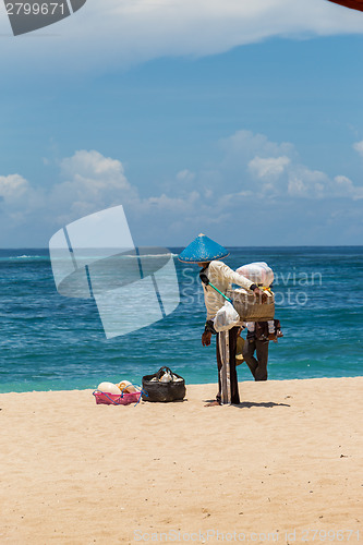 Image of Woman selling seashells on a beach in Bali