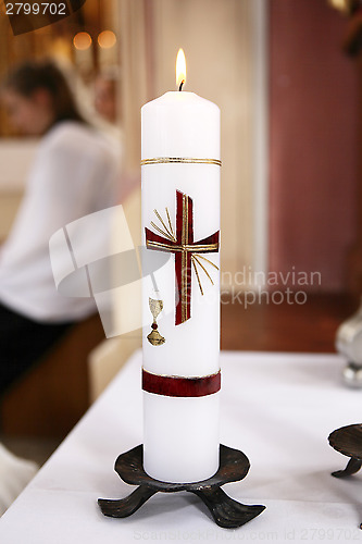 Image of Burning candle in church