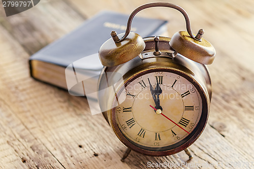 Image of Clock and Bible on wood