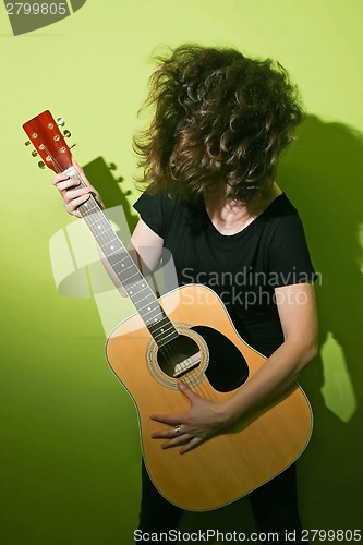 Image of Guitar woman tousling hair