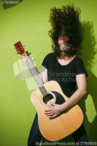 Image of Guitar woman shaking hair