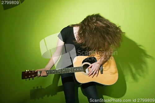 Image of Woman posing with guitar