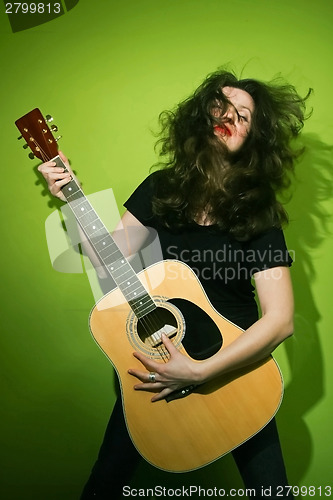 Image of Woman playing rock guitar