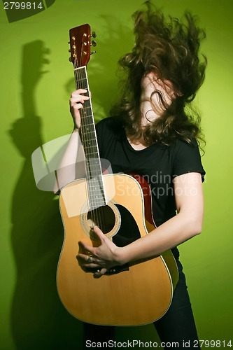 Image of Woman holding guitar