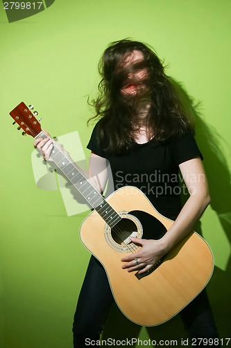 Image of Woman holding rock guitar